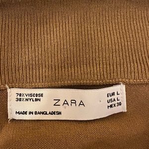 light brown zip up jacket.